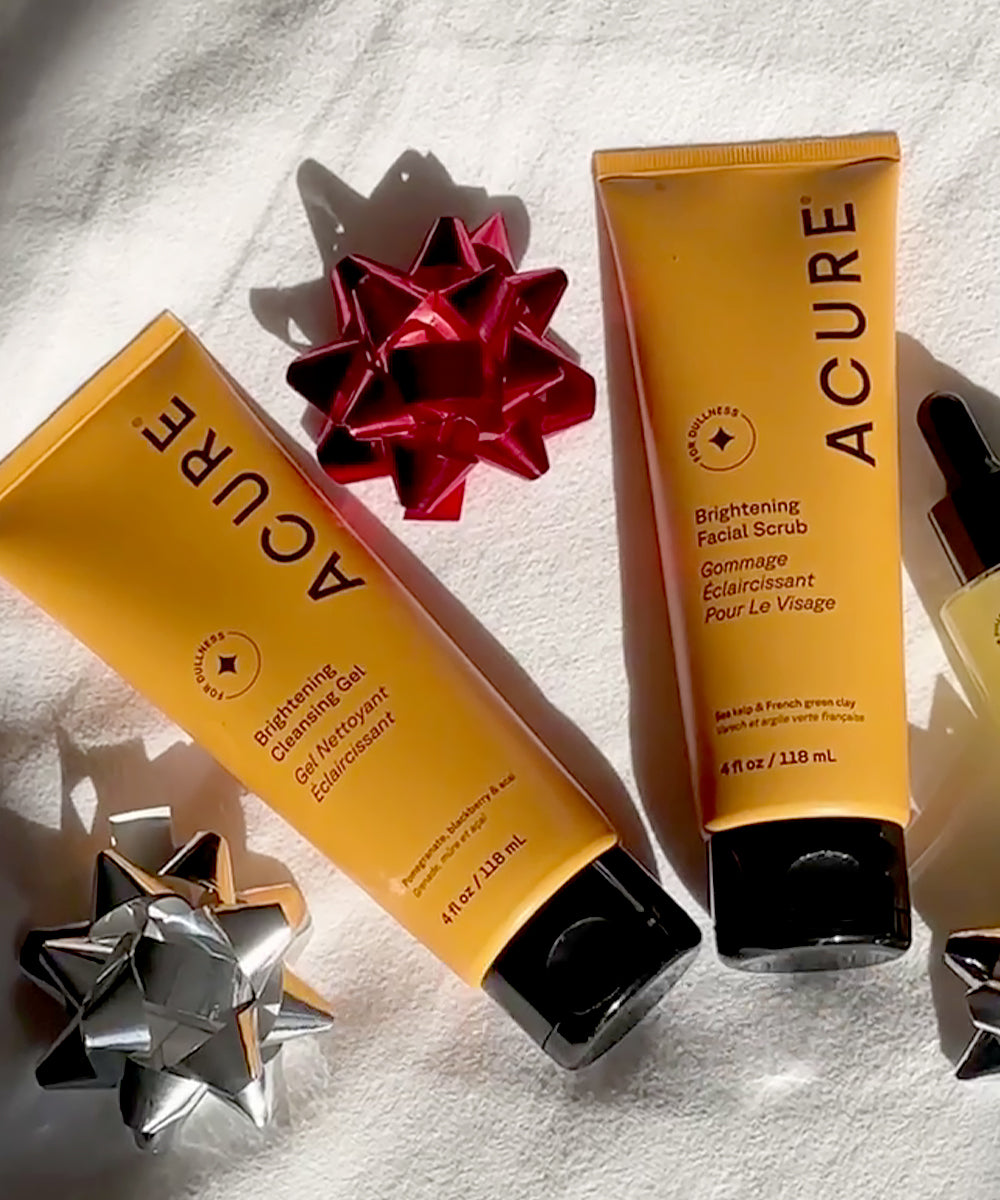 Two Acure skincare products with decorative bows on a light background