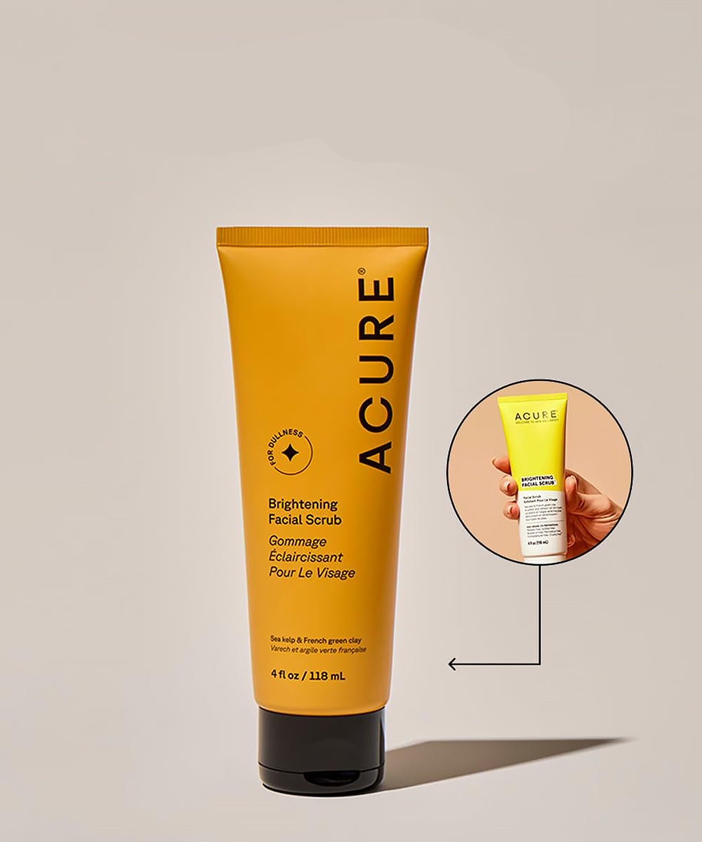 Acure brightening facial scrub tube on a beige background