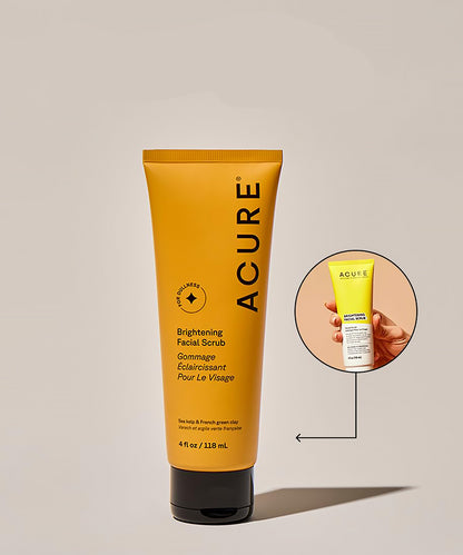 Acure brightening facial scrub tube on a beige background
