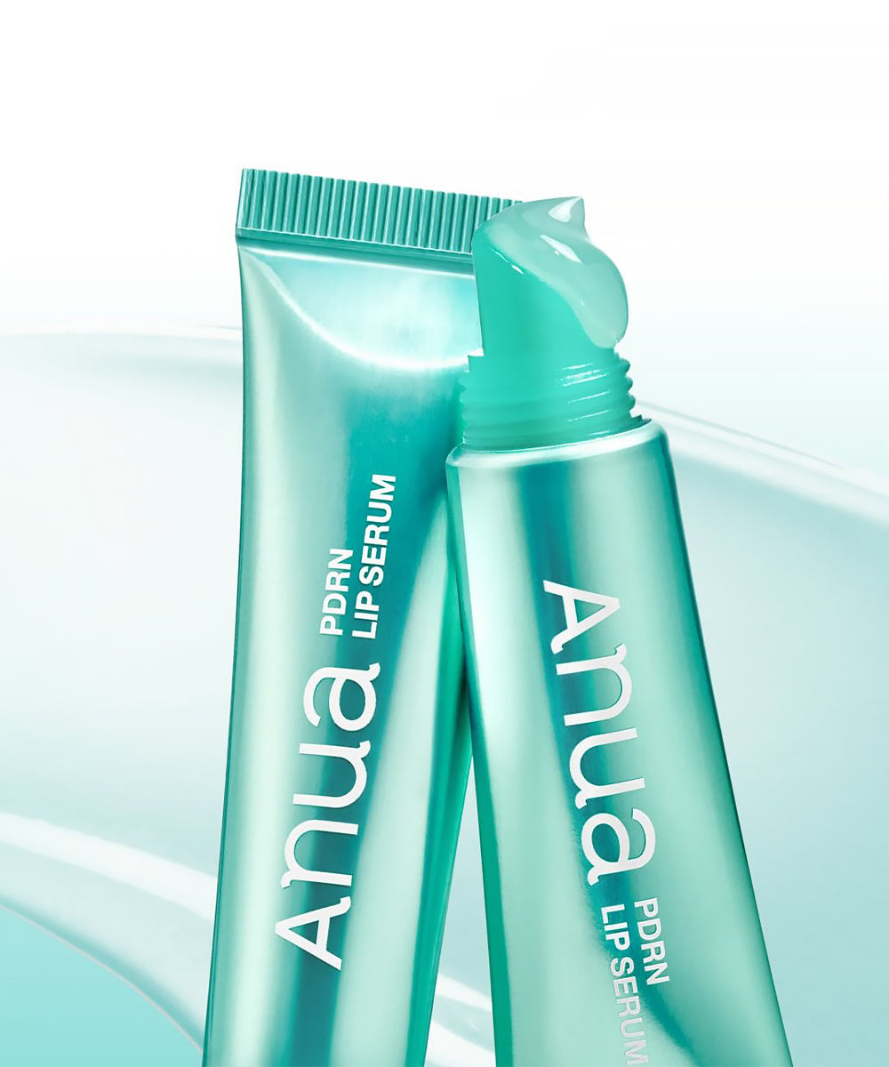 A close-up swatch of the Anua Lip Serum showing the clear, high-shine gloss texture with visible teal active capsules