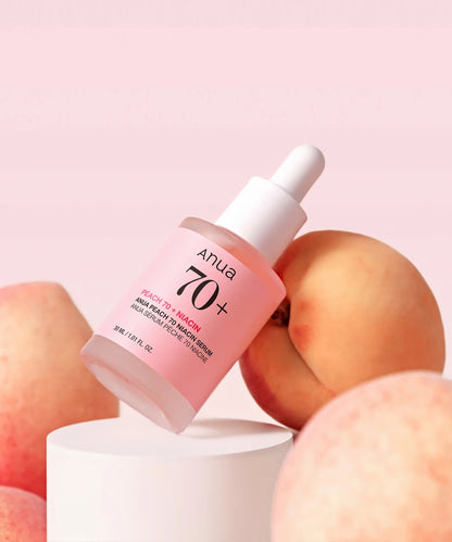 Skincare serum bottle with peaches on a pink background