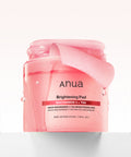 Pink jar of Anua Brightening Pad on a white background