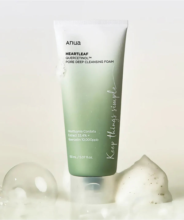 Tube of Anua Heartleaf cleansing foam with bubbles on a light background