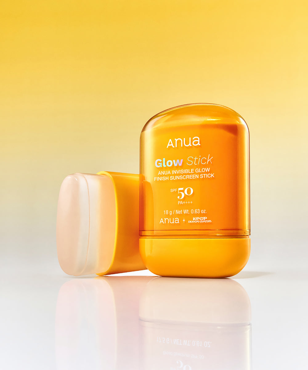 Anua Glow Stick sunscreen on a gradient yellow and white background
