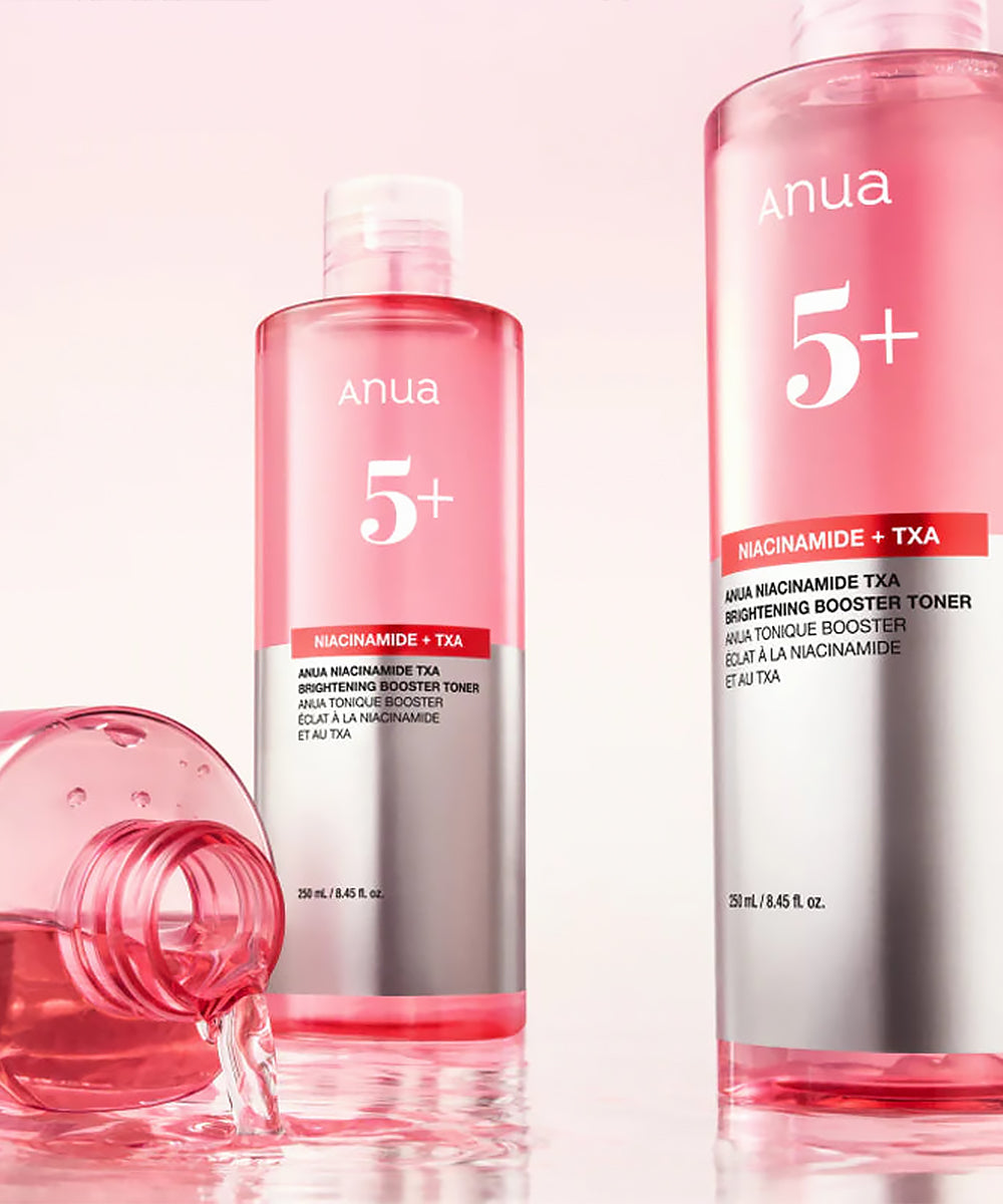 Two bottles of anua skincare products on a pink background