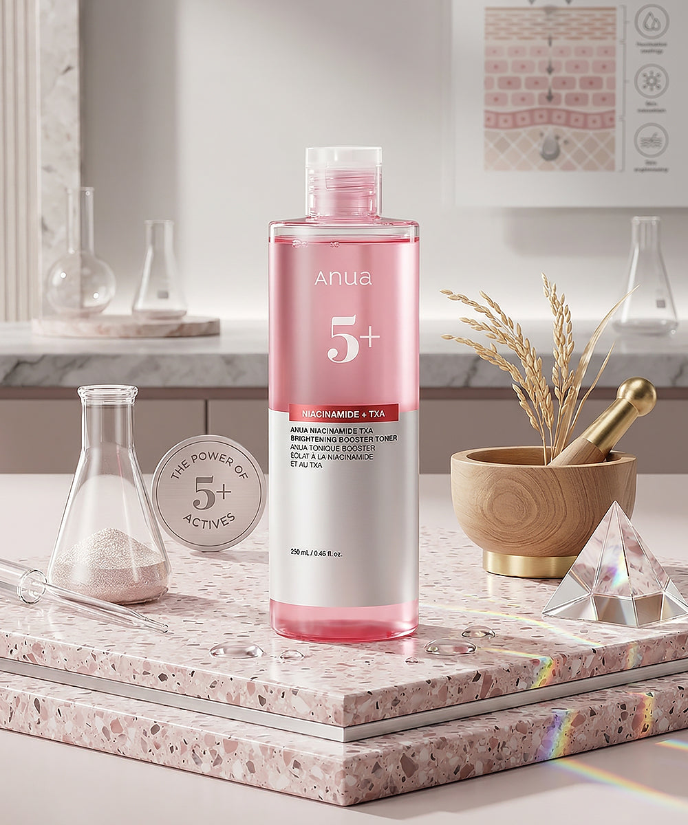 Pink skincare bottle with white label on a marble surface