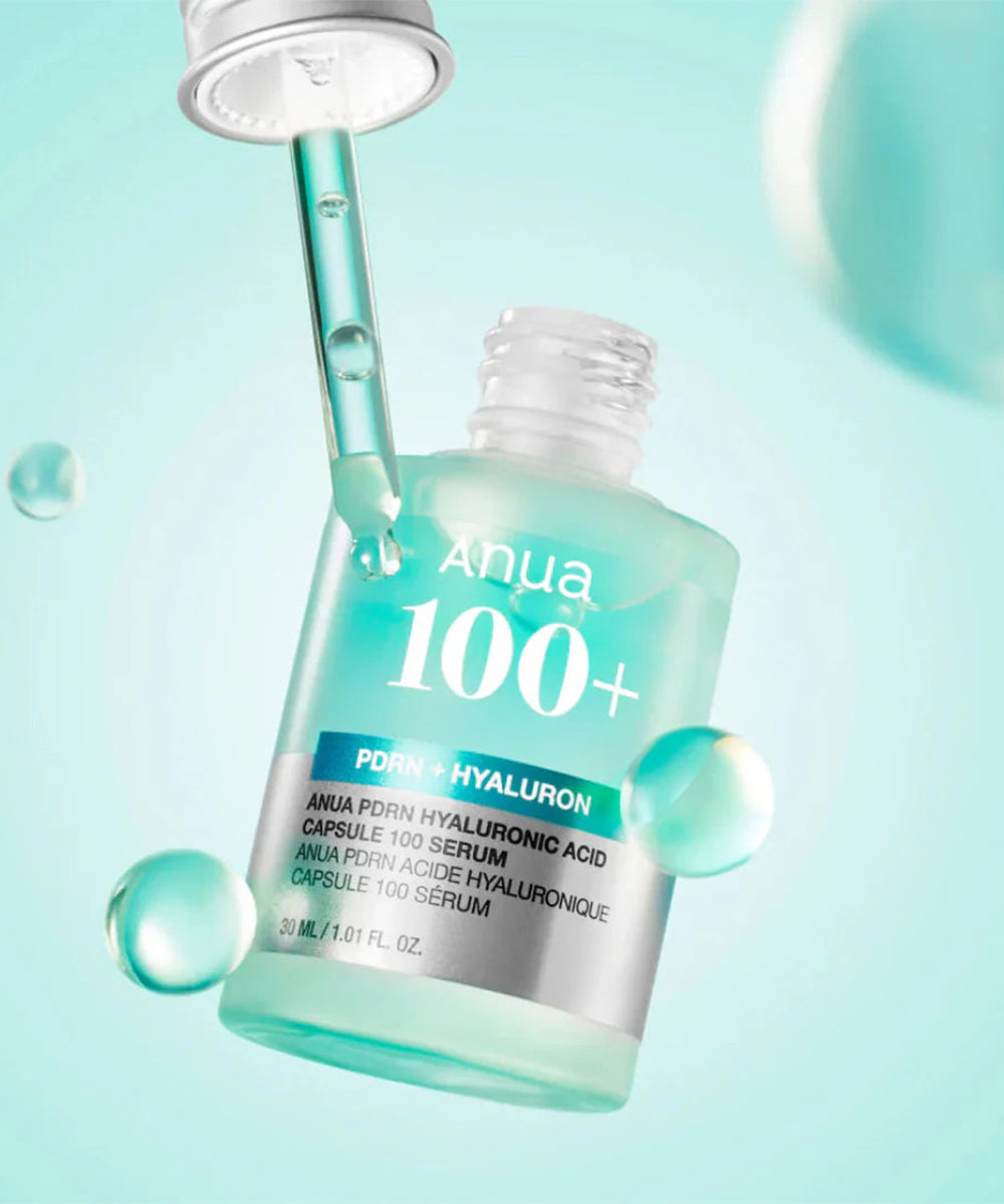 Anua 100+ serum bottle with dropper on a light blue background