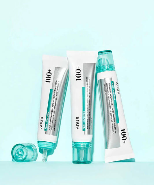 Three tubes of Anua 100+ skincare product on a light blue background