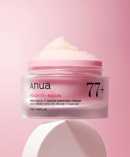 Anua Peach 77 + Niacin enriched cream jar on a pink background