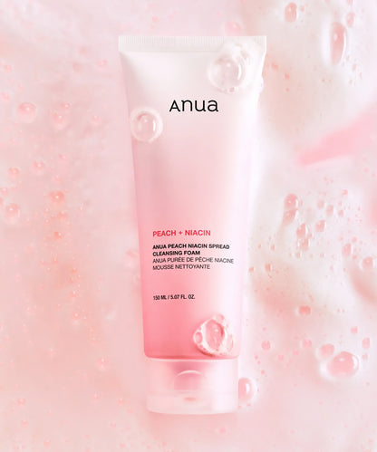 Anua Peach + Niacin cleansing foam packaging on a pink background with bubbles