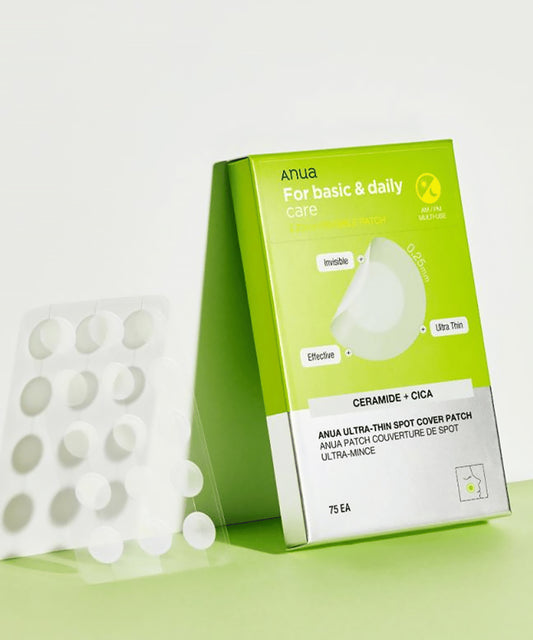 Green box of Anua spot cover patches with white patches on a light green background