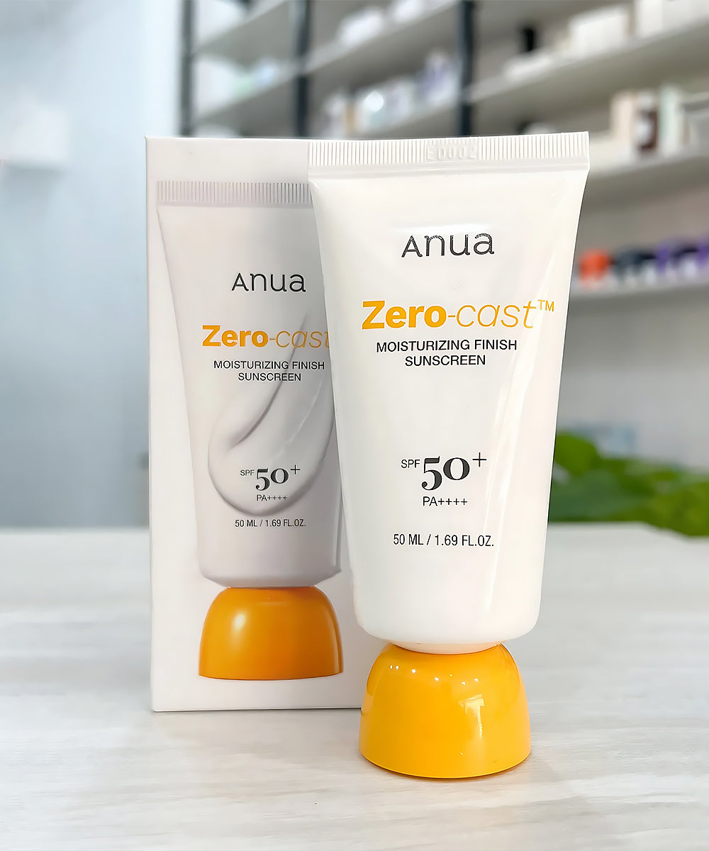 Two tubes of Anua Zero-cast sunscreen on a white surface with a blurred background.
