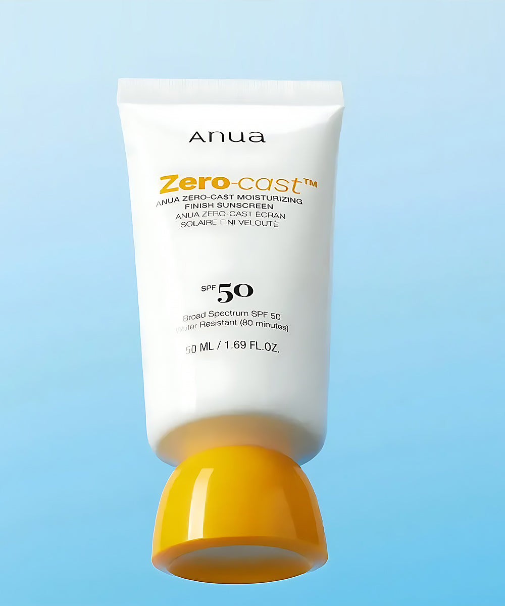 Anua Zero-Cast sunscreen tube with yellow cap on a light blue background