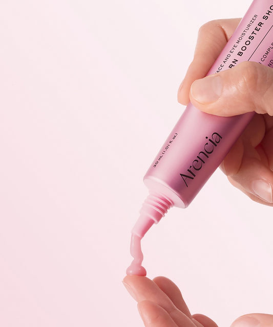 Close-up of a hand dispensing the Arencia PDRN Booster Shot, showcasing the smooth, light pink gel-cream texture being applied to a fingertip