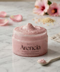 Jar of Arencia cloud body and scalp scrub on a marble surface with flowers in the background