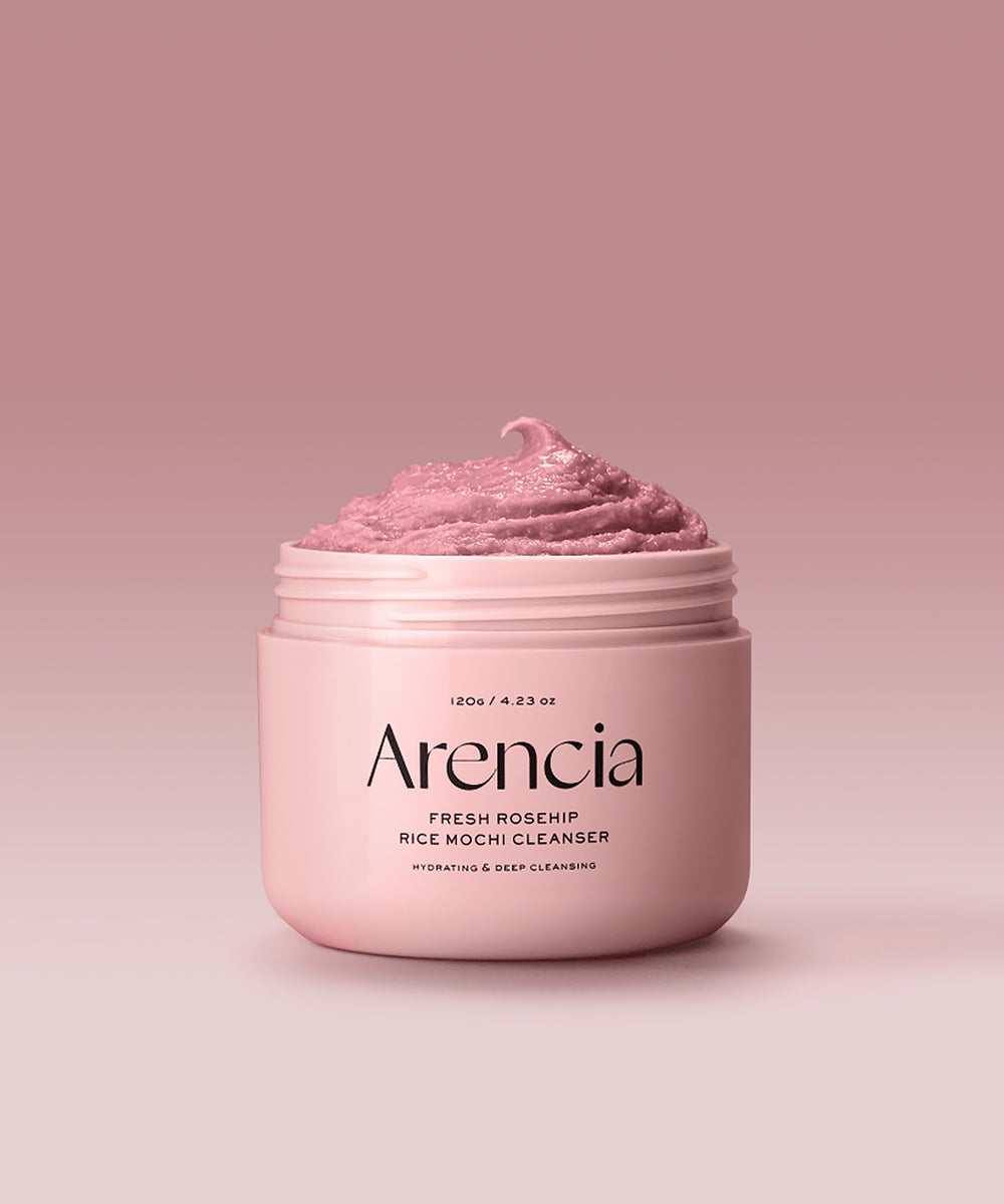 Pink jar of Arencia facial cleanser on a pink background