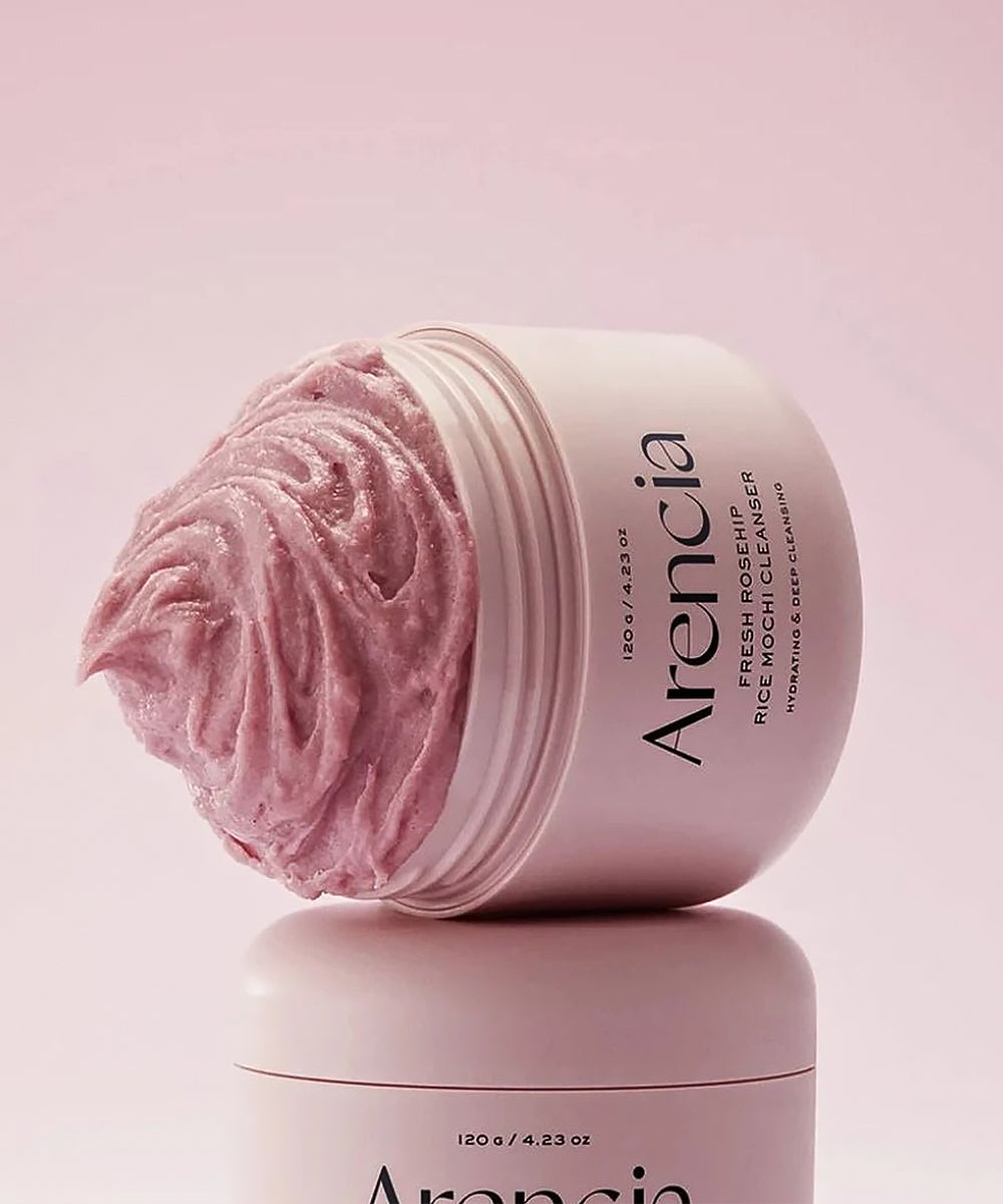 Pink cream in an open jar with 'Arencia' branding on a pink background