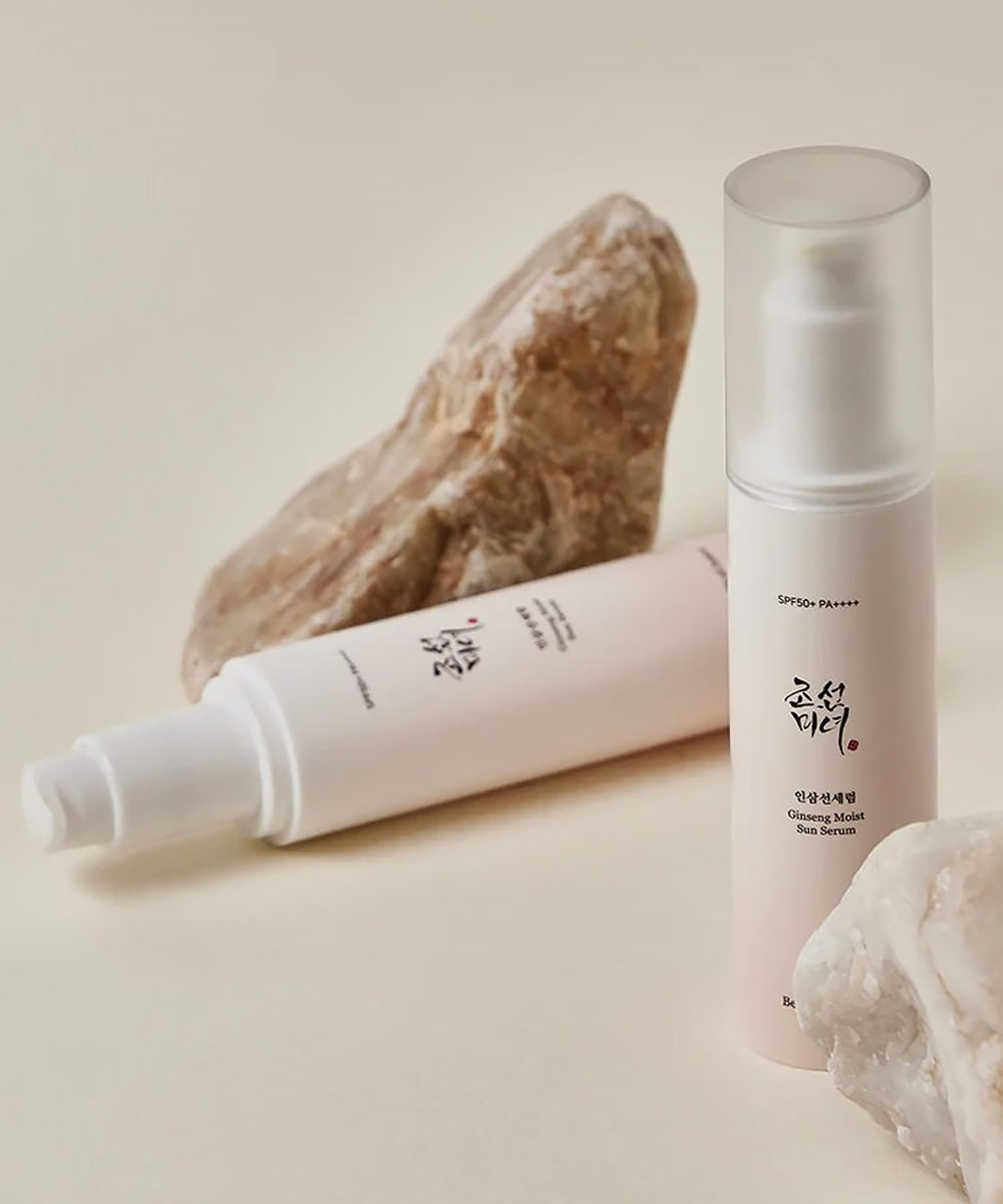 Two skincare products with natural rock elements on a beige background