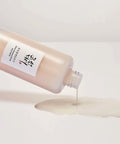 Bottle of skincare product with a label on a light background