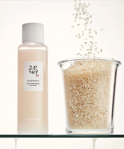 Skincare product bottle with a glass container of rice scrub on a white background