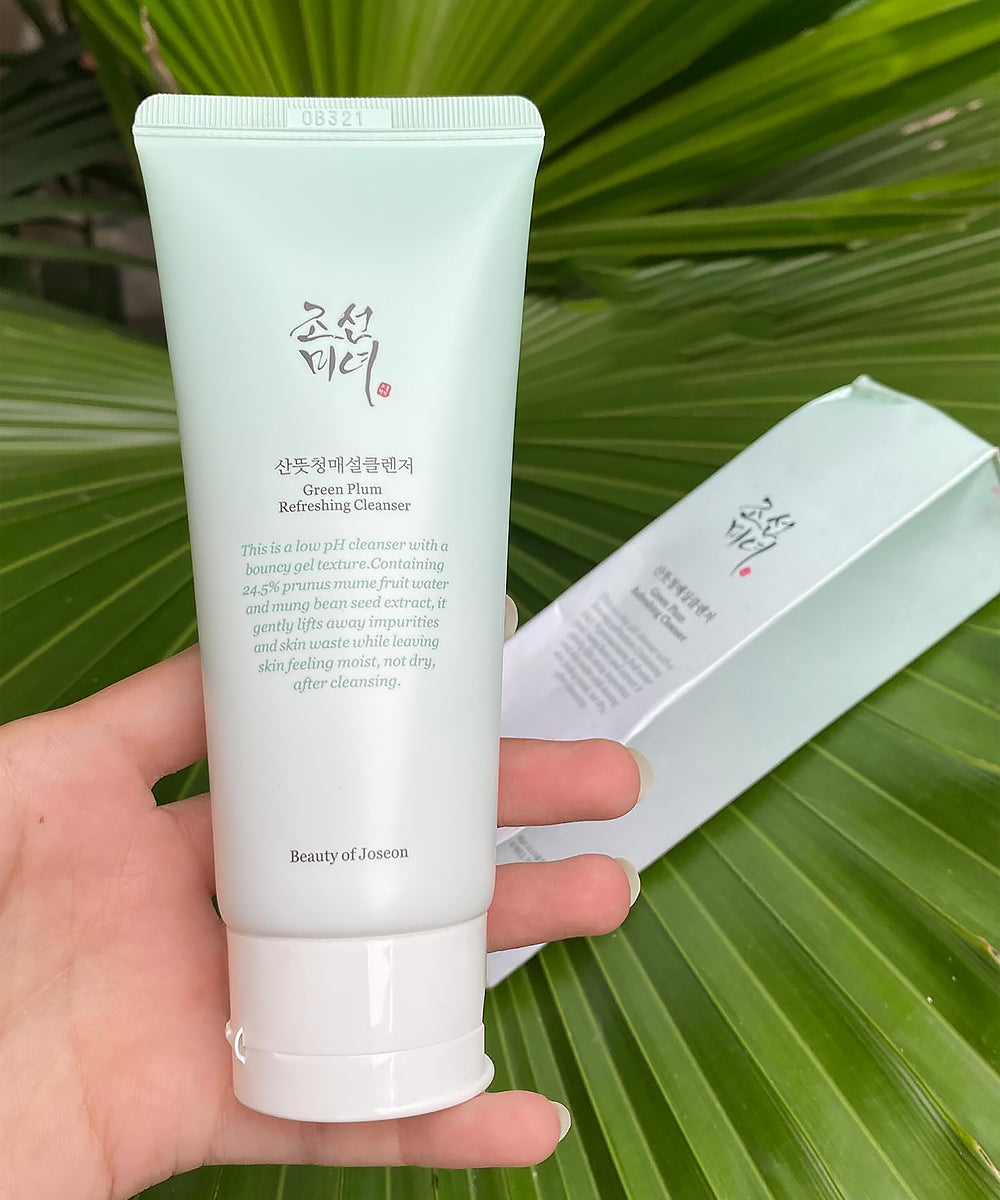 Tube of Beauty of Joseon Green Plum Cleanser held against a green leafy background