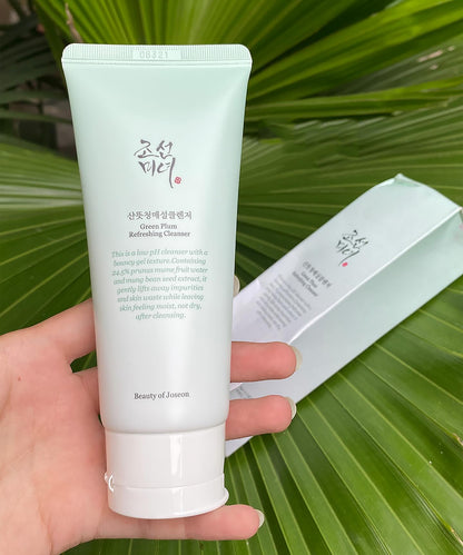 Tube of Beauty of Joseon Green Plum Cleanser held against a green leafy background
