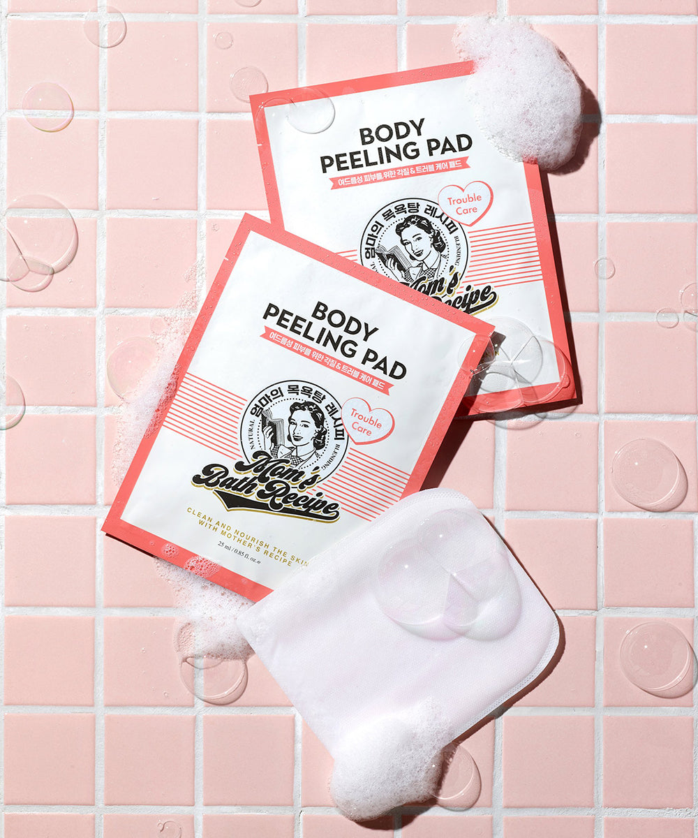 Body peeling pads with a white pad on a pink tiled background