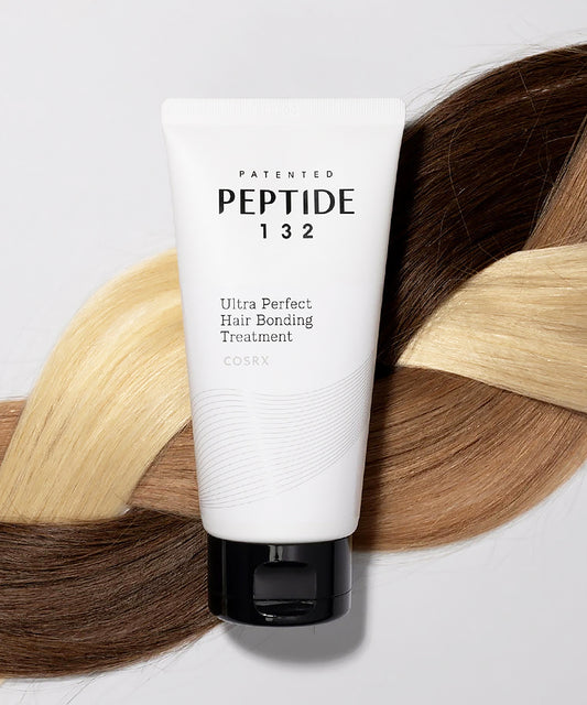 Tube of Peptide 132 hair bonding treatment with braided hair in the background