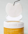 Pore and dark spot brightening pad container with applicator on a gray background