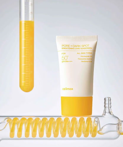 Cosmetic tube with yellow liquid and a bottle cap on a light gray background