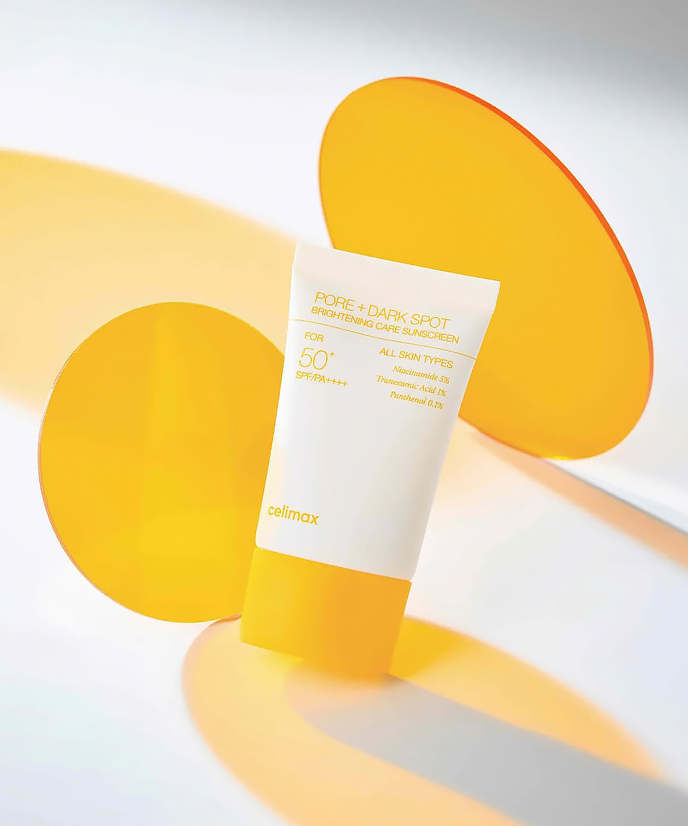 Sunscreen tube with yellow and white design on a light gray background