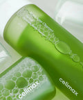 Two green bottles of celimax acne cleanser on a white background