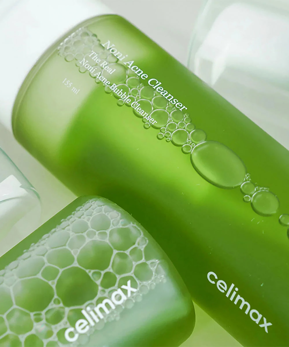 Two green bottles of celimax acne cleanser on a white background