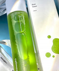 Green toner bottle with white cap on a blurred background