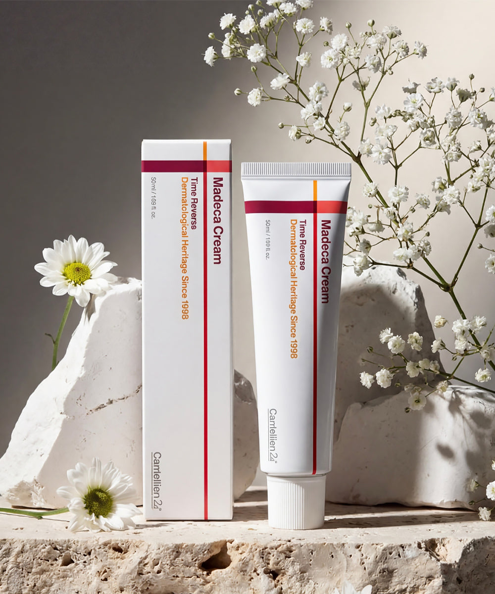 Madeca Cream tube and packaging on a stone surface with white flowers