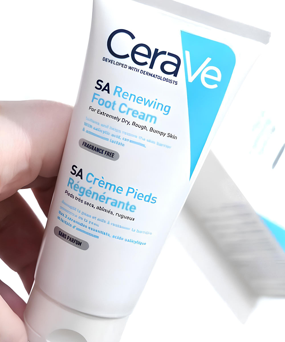 CeraVe SA Renewing Foot Cream tube held by a hand on a white background