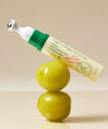 Vegan collagen eye serum with green applicator on a beige background