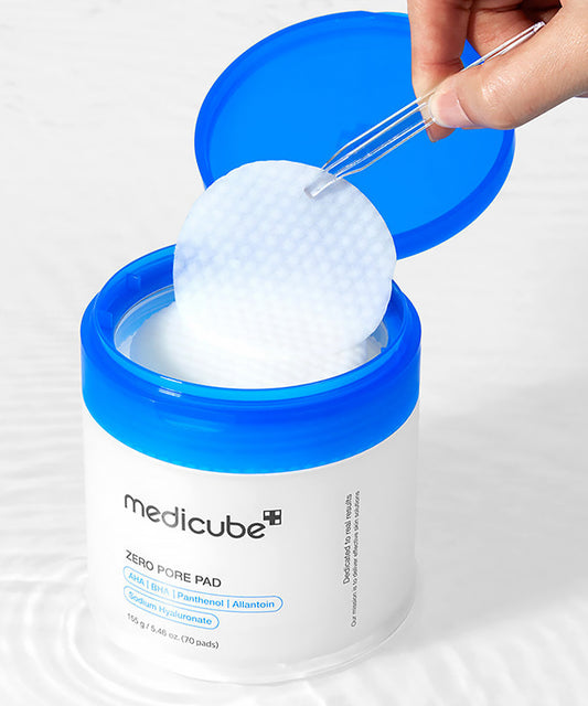 Medicube zero pore pad container with a hand holding a pad against a white background