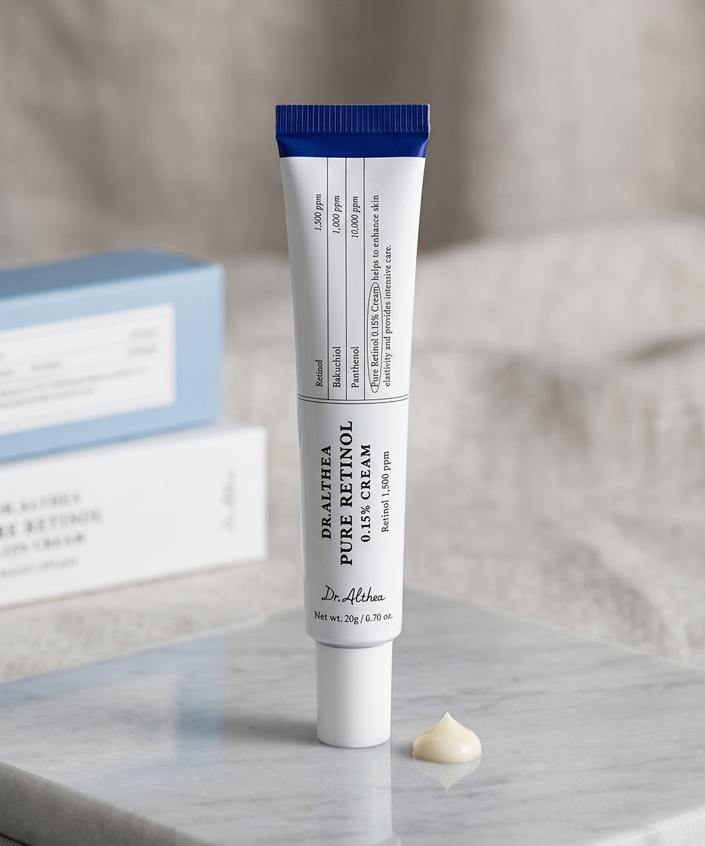 A hand holding the Dr. Althea Pure Retinol 0.15% Cream tube, showcasing the sleek, minimalist design and compact, travel-friendly size