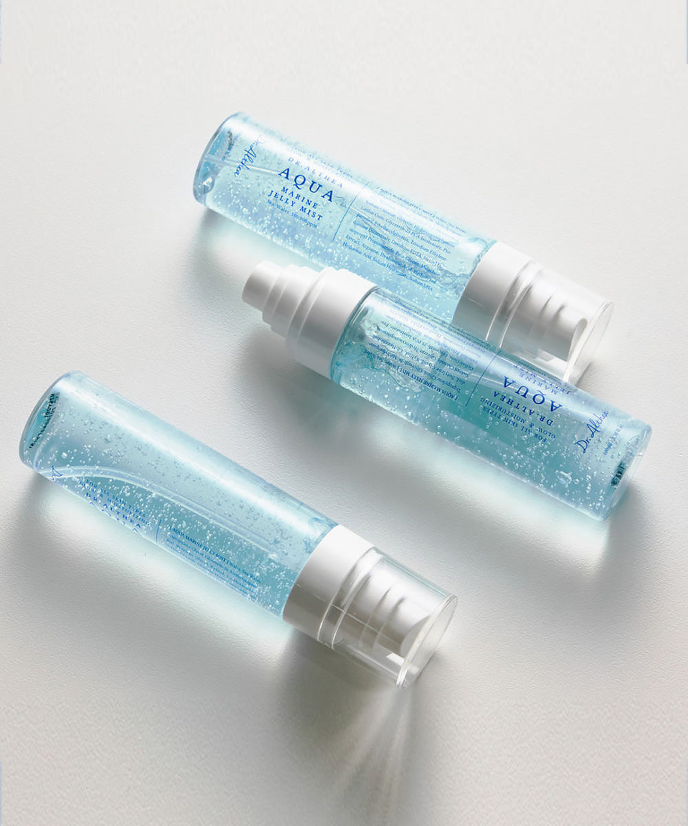 Three blue skincare bottles labeled 'Aqua' on a light gray background