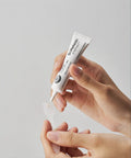 Close-up texture shot showcasing a smooth dollop of the Dr. Melaxin Eye Cream being dispensed from its fine-point nozzle to demonstrate its creamy consistency