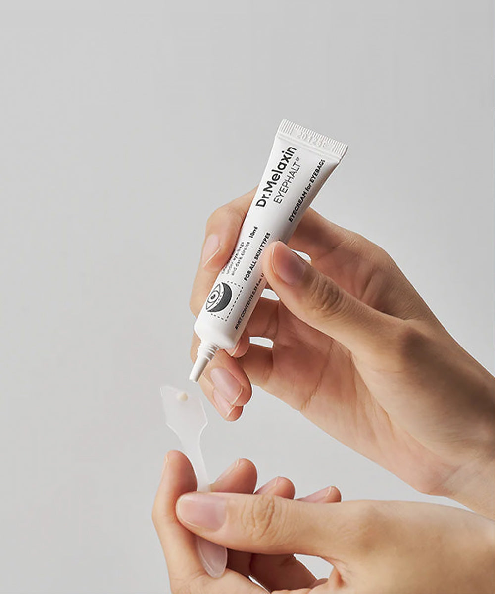 Close-up texture shot showcasing a smooth dollop of the Dr. Melaxin Eye Cream being dispensed from its fine-point nozzle to demonstrate its creamy consistency