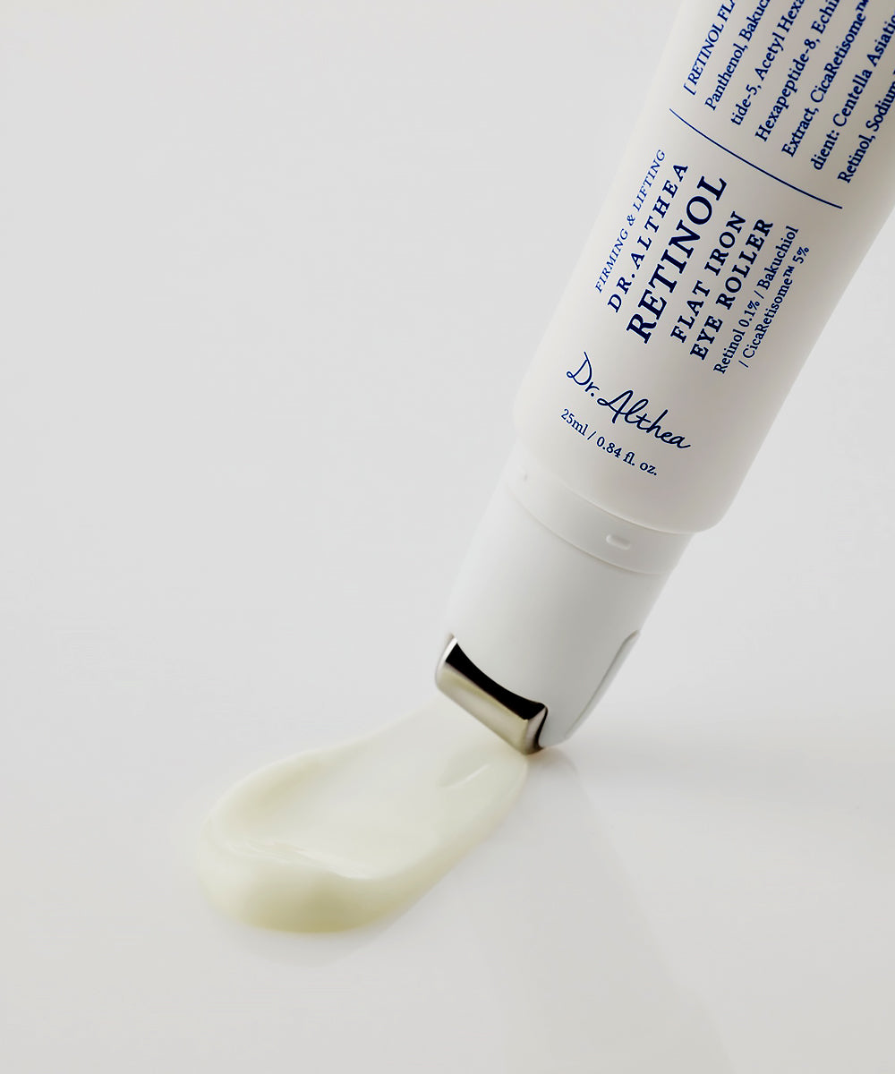 Macro shot showing the smooth, creamy texture of the Dr. Althea Retinol treatment being dispensed through the "flat iron" metal applicator on a reflective white surface