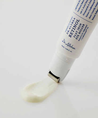 Macro shot showing the smooth, creamy texture of the Dr. Althea Retinol treatment being dispensed through the "flat iron" metal applicator on a reflective white surface