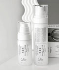 Two skincare products with labels on a neutral background