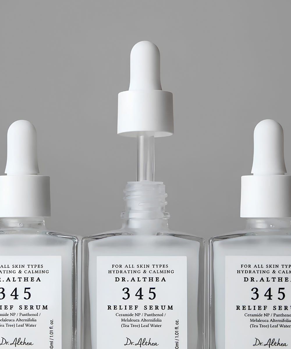 Three clear glass dropper bottles of Dr. Althea 345 Relief Serum arranged symmetrically against a neutral gray background.