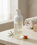 Foam cleanser bottle with text on a neutral background