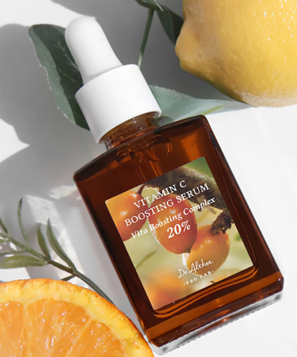 Vitamin C boosting serum bottle with oranges and leaves on a light background