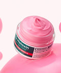 Aesthetic lifestyle shot of the Dr. Melaxin Calcium B12 Spicule Cream resting on a textured, light-colored stone surface with soft, natural shadows