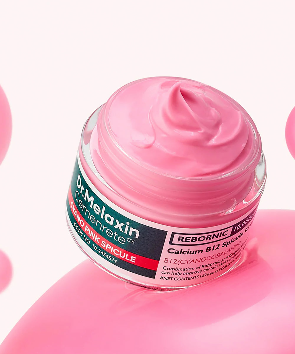 Aesthetic lifestyle shot of the Dr. Melaxin Calcium B12 Spicule Cream resting on a textured, light-colored stone surface with soft, natural shadows